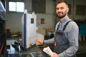 Graphic engineer or worker checking imprint quality in modern print shop photo