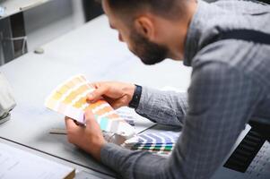 Graphic engineer or worker checking imprint quality in modern print shop photo