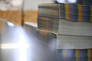 paper pile in a finishing, folder station in an offset printer photo