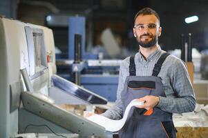 Man working in printing house with paper and paints photo