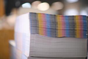 paper pile in a finishing, folder station in an offset printer photo