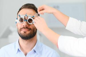 man checking up vision with special ophthalmic glasses photo