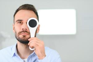 retrato, visión y cuchara con un hombre paciente a el optometrista para un ojo examen pruebas su profundidad percepción foto