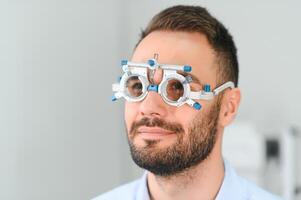 man checking up vision with special ophthalmic glasses photo