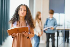 Portrait of cute African-American girl at school photo