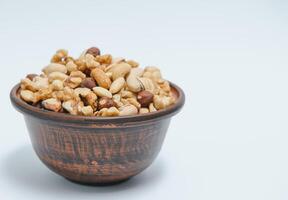 Various nuts on a plate, top view. photo