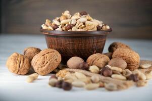 Mixed nuts on wood floor. Organic and fresh nuts. Copy space photo