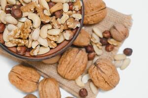 Various nuts on a plate, top view. photo