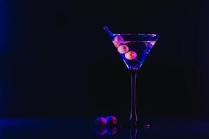 Martini cocktail drink splash with ice cubes in neon iridescent pink and blue colors. Minimal night party life concept. photo