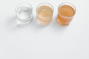 Water filters. Concept of three glasses on a white background. Household filtration system. photo