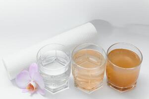 Water filters. Concept of three glasses on a white background. Household filtration system. photo