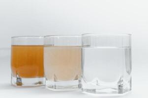 Water filters. Concept of three glasses on a white background. Household filtration system. photo