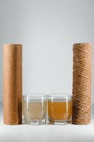 used water filters, glasses with dirty water photo