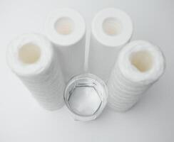 filter cartridges for water on a white background. Installation of reverse osmosis water purification system. photo