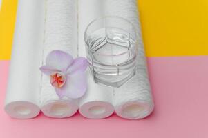 cartridges for water purification on a colored background. Concept of clean water at home photo