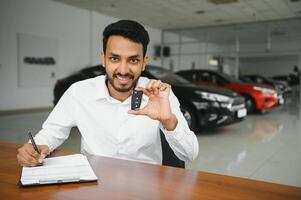 Closeup portrait happy, smiling, young man, buyer showing keys of his new car photo