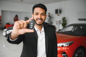 Closeup portrait happy, smiling, young man, buyer showing keys of his new car photo