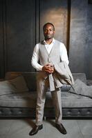 A handsome young african gentleman buying an elegant suit photo