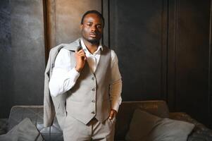 A handsome young african gentleman buying an elegant suit photo