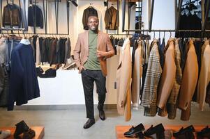 Handsome young african man wearing suit in shop photo