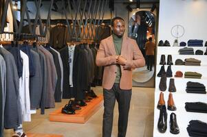 Handsome young african man wearing suit in shop photo