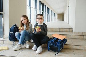 School kids in uniform together in corridor. Conception of education. photo