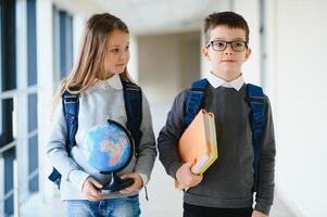 School kids in uniform together in corridor. Conception of education. photo