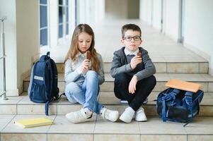 School kids in uniform together in corridor. Conception of education. photo