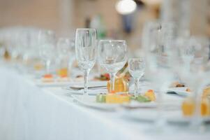 beautifully laid tables with glasses and appliances at morning in restaurant. photo