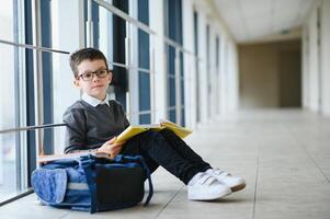 Portrait of cute school boy with backpack. Schoolboy with a backpack at school. Back to school. photo