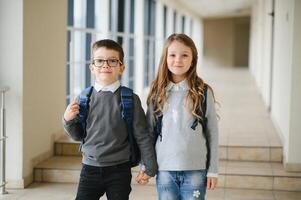 School kids in uniform together in corridor. Conception of education. photo