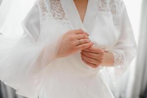 Bride dressing wedding gown. morning bride. photo