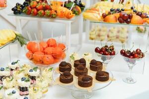 various dessert with fresh fruit on buffet line, sweet. photo