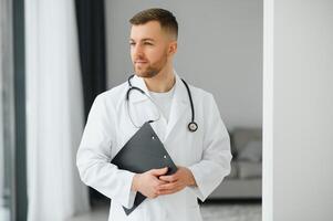handsome male doctor portrait in office photo