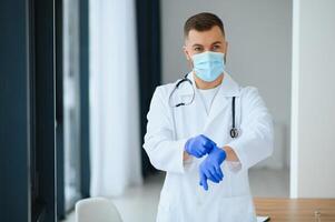 Portrait of male doctor wearing surgical mask is ready to help patients with coronavirus or covid virus. photo