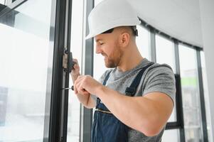 Construction worker installing window in house photo