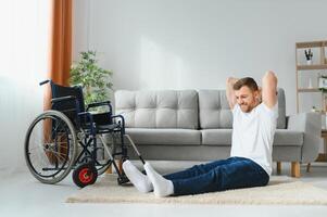 Disabled sportsman doing stretching and exercises on wheelchair background. Life of a disabled person photo