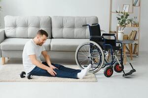 Disabled sportsman doing stretching and exercises on wheelchair background. Life of a disabled person photo