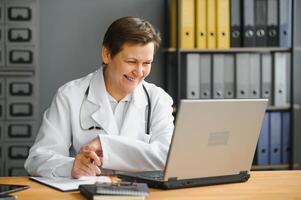 Mid age female doctor writing prescription photo