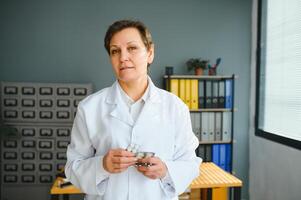 Portrait of senior female doctor in her office. photo