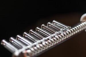 Close up shot of the high frequency comb tool for hair and scalp treatment. Healthcare photo