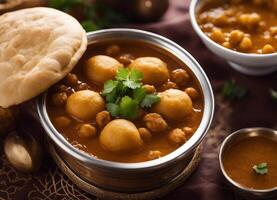 AI generated Chole masala with naan, garnished with cilantro photo