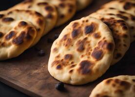 AI generated Freshly baked Indian naan flatbread on a wooden board photo