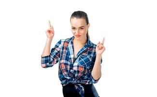 Woman Wearing Plaid Shirt Gesturing with Two Fingers. A woman in plaid shirt holding up two fingers photo