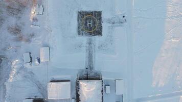 Helipad snowy field surrounded by forest northern solitude Helipad symbol air mobility frosty nature. Helipad connecting remote snowy landscapes Point of connection in world of ice and snow. video