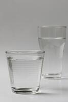 Glasses of Drinking Water on Clear Background photo