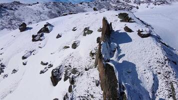 View from a drone of the rocks on the northern slope of Elbrus in sunny weather video