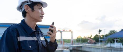 maintenance and inspector. Maintenance engineers are using walky talky to inform the results of inspection of buildings and structures. Irrigation engineers are exploring sluice systems photo