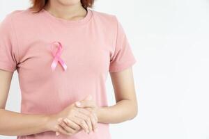 Woman hold pink ribbon breast cancer awareness. Female health check consciousness. international Women Day and World Cancer Day. sign cancer, Symbolic, health care, support patients, timely diagnosis photo