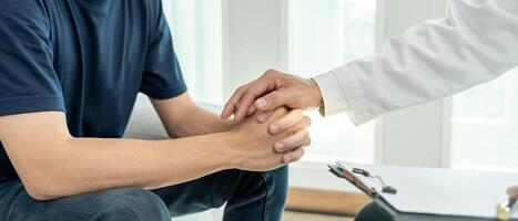 psychiatrist hold hand support each while discussing family issues. doctor encourages and empathy man suffers depression. psychological, save divorce, Hand in hand together, trust, care photo